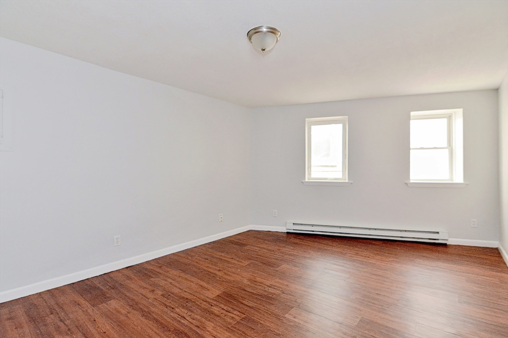 2-6 North Main Street Rochester, NH 03867 - Photo 30 of 40 an empty room with wooden floor and windows