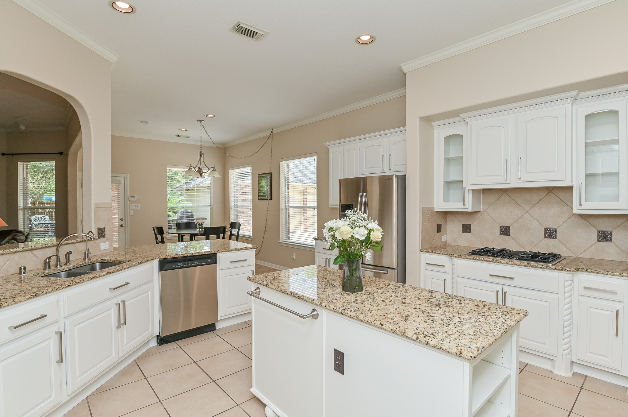 7218 Spring Run Lane Katy, TX 77494 - Photo 12 of 49 a kitchen with white cabinets sink and stove