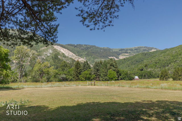 2807 North Ogden Canyon Road Eden, UT 84310 - Photo 54 of 72 Expansive grassy field with distant forested mountains and a clear blue sky