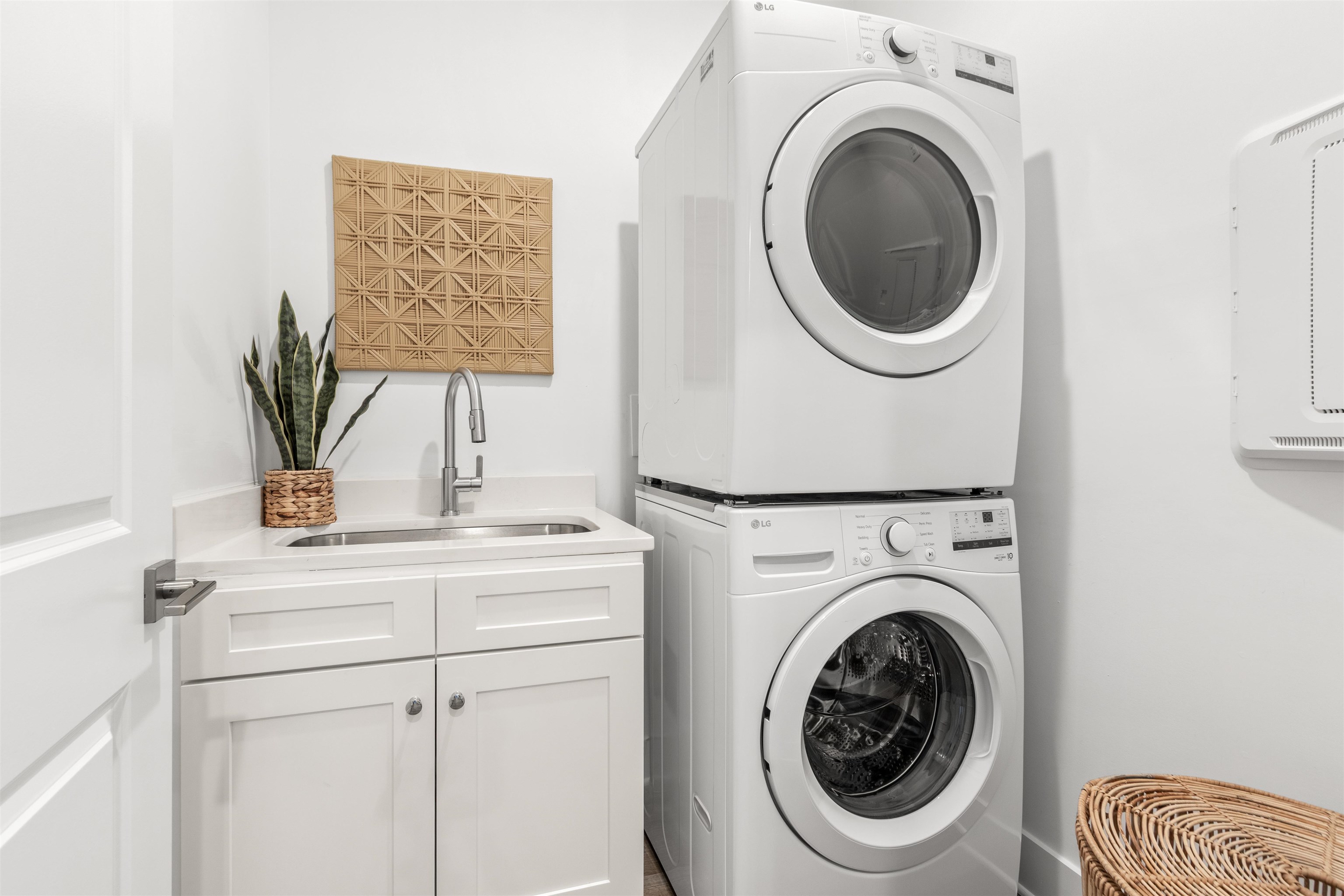 6779 Magnolia Lane St. Augustine, FL 32086 - Photo 24 of 61 Laundry room with estacked washer and dryer and cabinet space