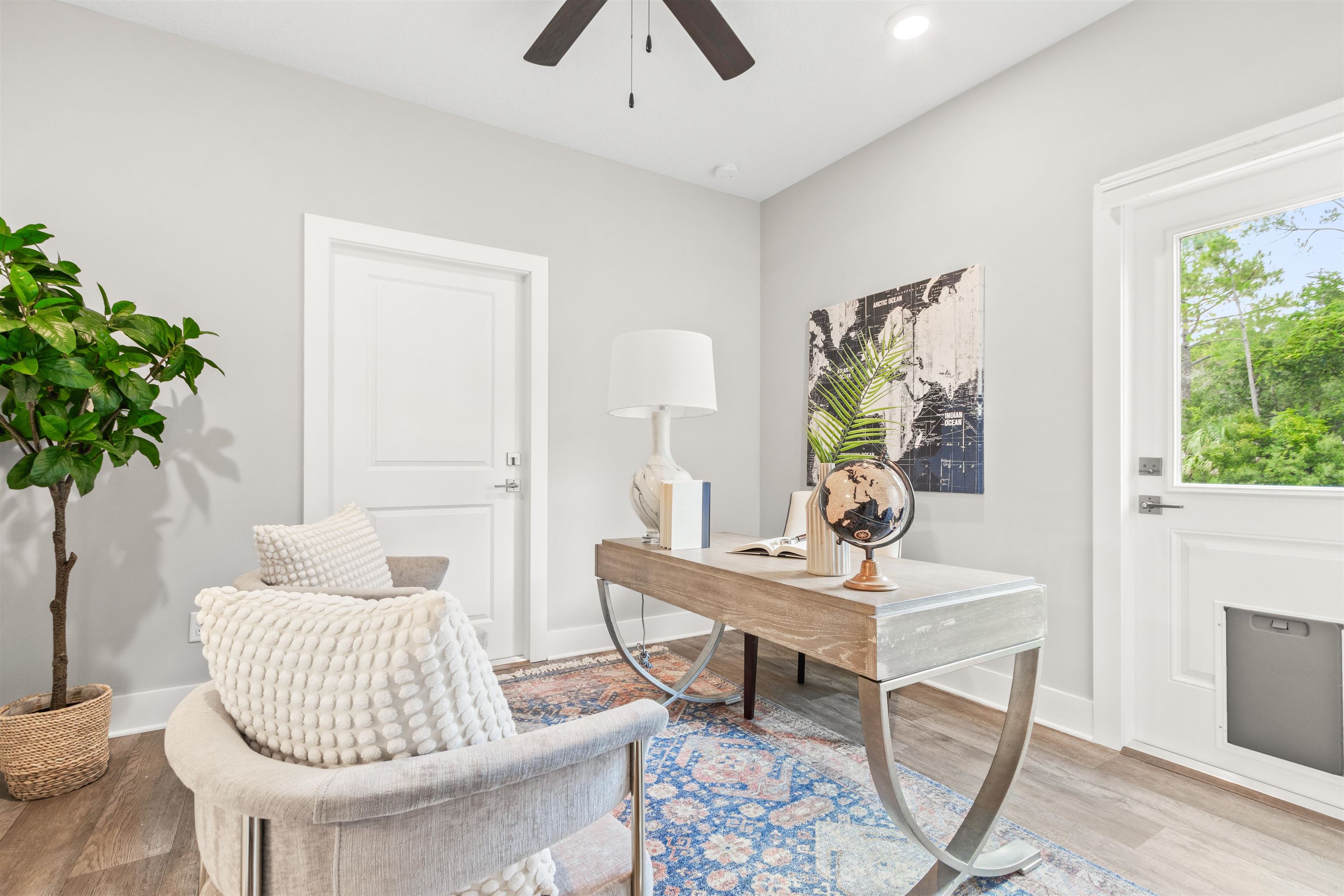 6779 Magnolia Lane St. Augustine, FL 32086 - Photo 25 of 61 a living room with furniture and a potted plant