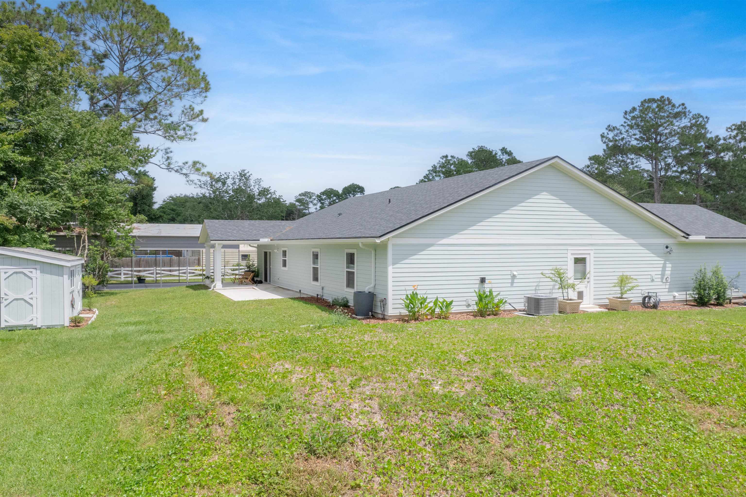6779 Magnolia Lane St. Augustine, FL 32086 - Photo 39 of 61 a view of a house with a yard
