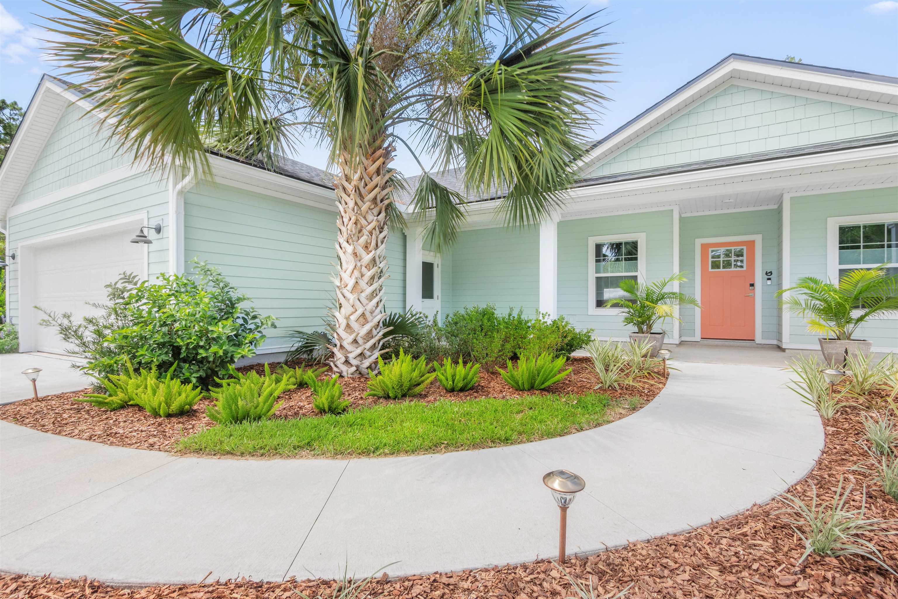 6779 Magnolia Lane St. Augustine, FL 32086 - Photo 40 of 61 a view of a white house with a yard and potted plants