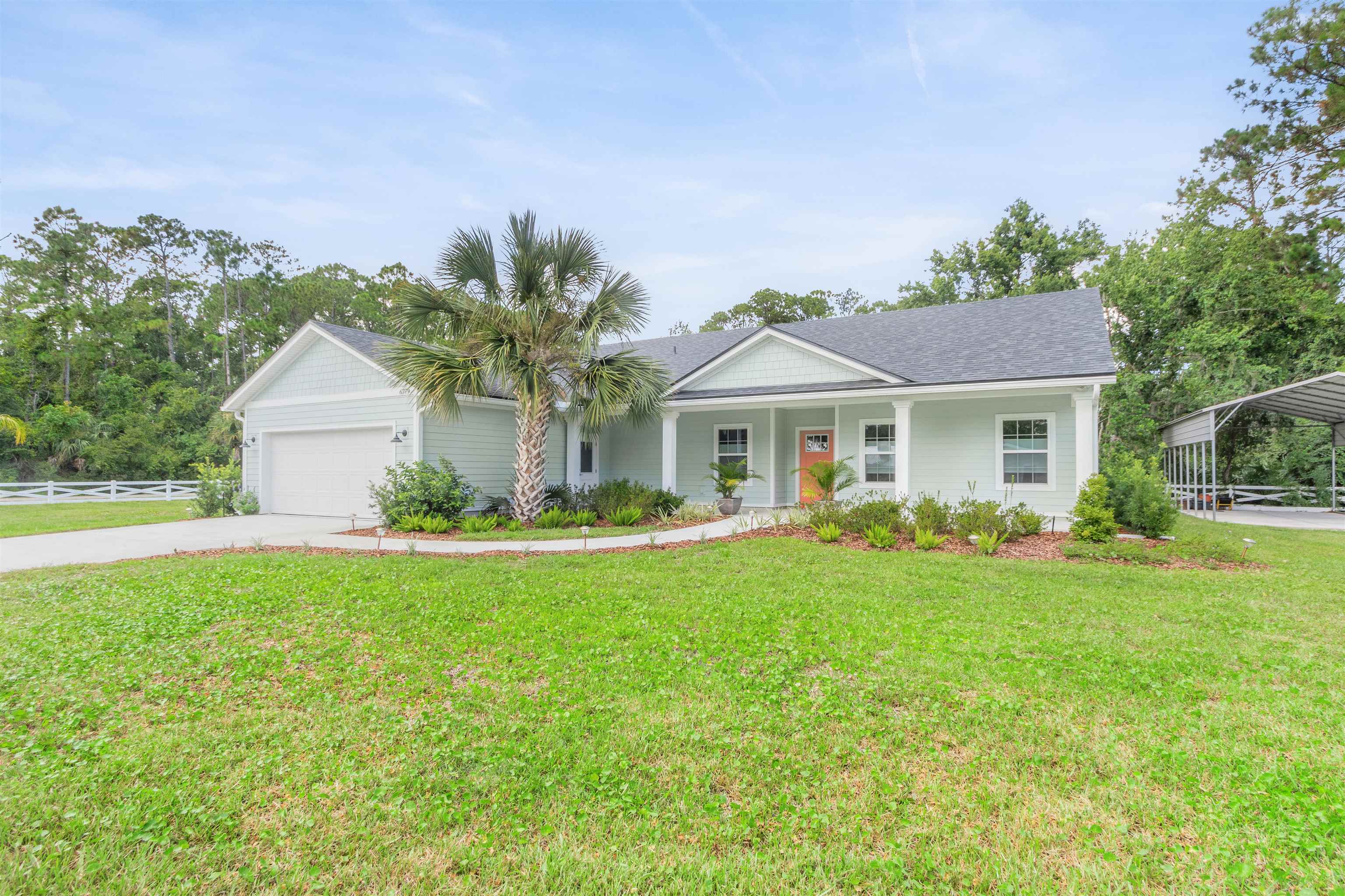6779 Magnolia Lane St. Augustine, FL 32086 - Photo 43 of 61 a front view of a house with garden