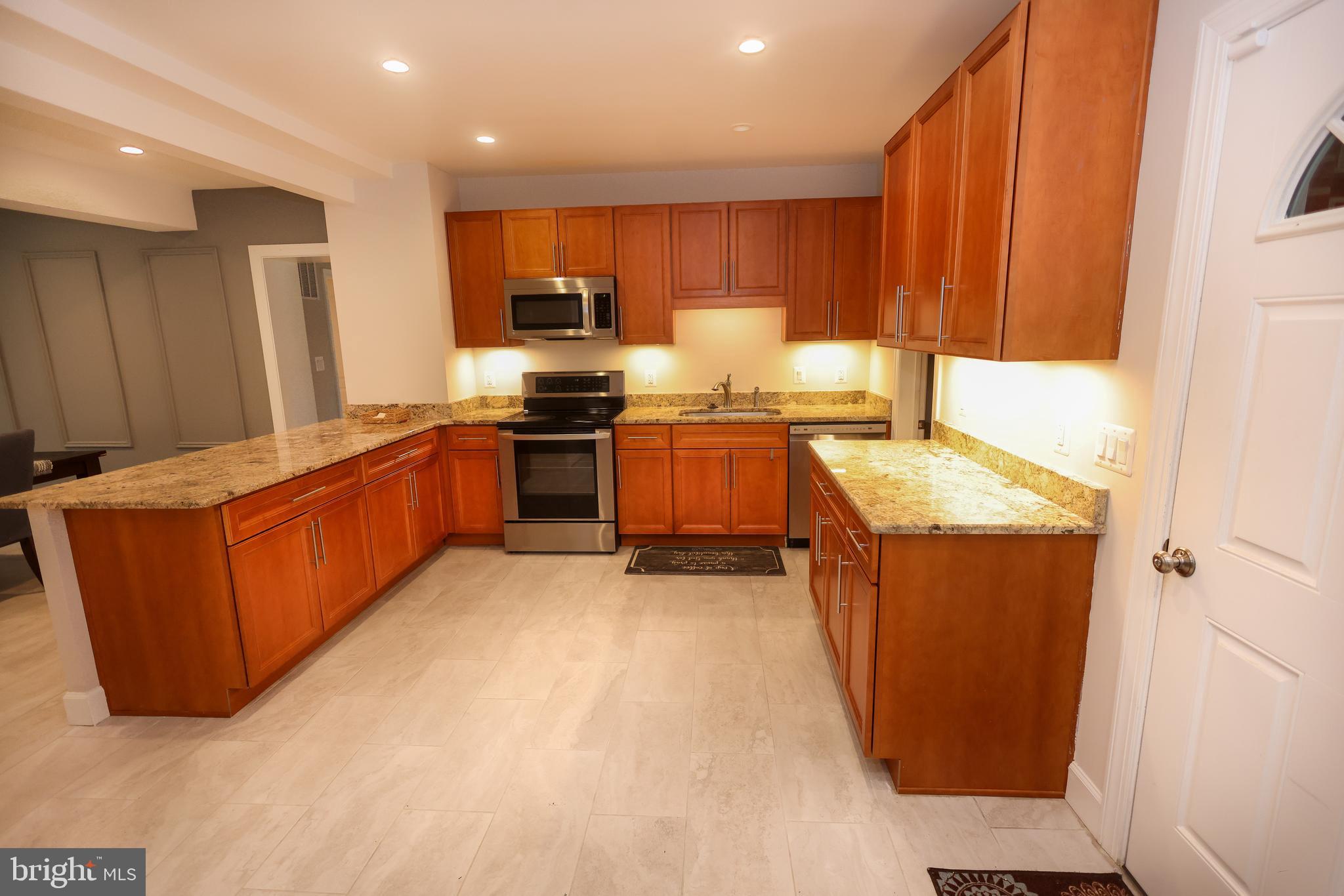 16600 Bald Eagle School Road Brandywine, MD 20613 - Photo 3 of 29 a kitchen with stainless steel appliances granite countertop a stove a sink a refrigerator and a microwave