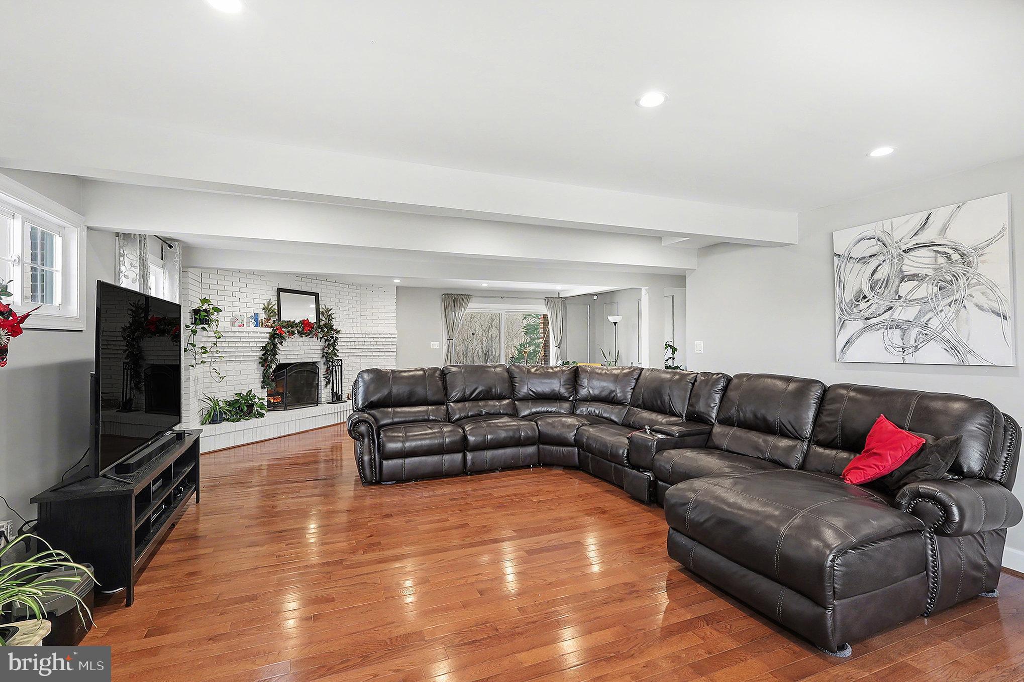 16600 Bald Eagle School Road Brandywine, MD 20613 - Photo 6 of 29 a living room with furniture flat screen tv and wooden floor