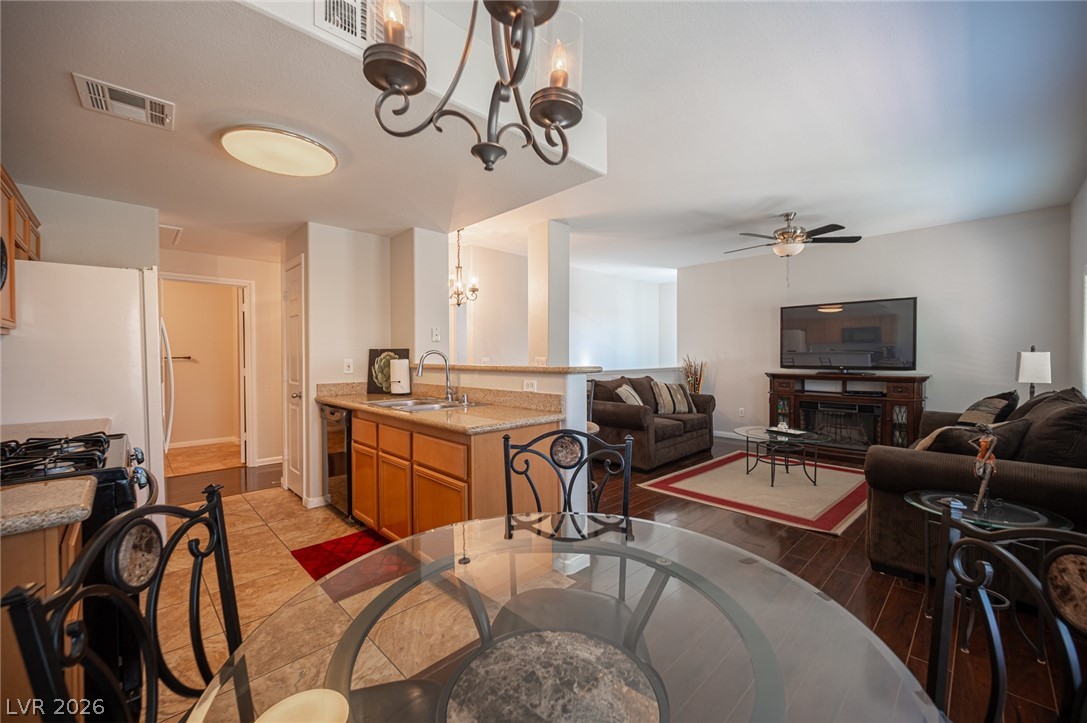 7701 West Robindale Road, Unit 274 Las Vegas, NV 89113 - Photo 12 of 38 An inviting open-concept living area seamlessly connects kitchen and living spaces, perfect for entertaining.