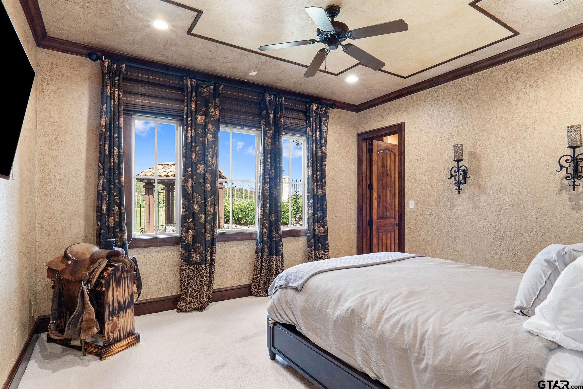 4331 Mark Hayes Court Tyler, TX 75709 - Photo 24 of 48 a bedroom with a bed next to a large window with a view of bedroom