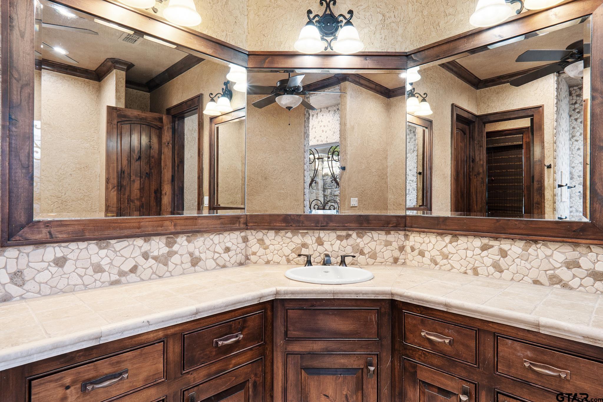 4331 Mark Hayes Court Tyler, TX 75709 - Photo 26 of 48 a bathroom with a sink and a mirror