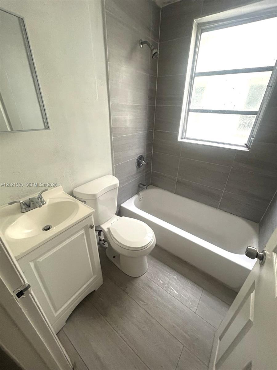 967 Southwest 5th Street, Unit 10 Miami, FL 33130 - Photo 8 of 9 a bathroom with a sink a toilet and bathtub