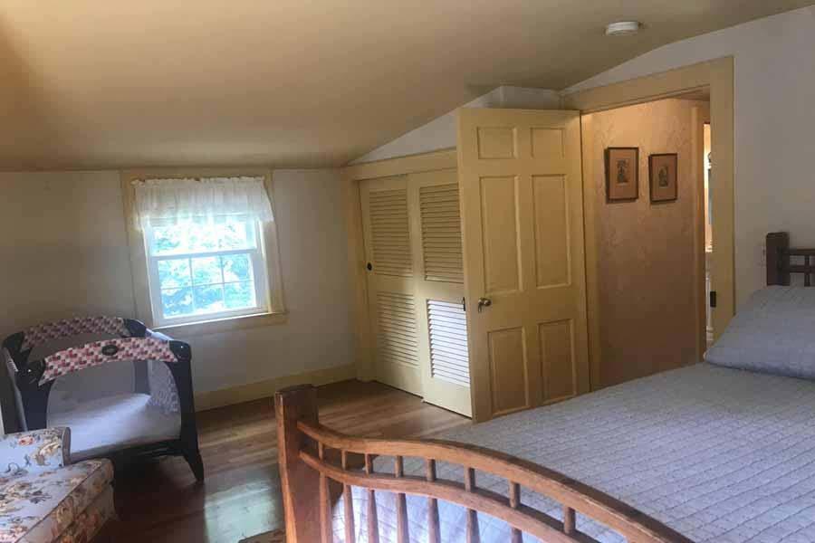 149 East Bay Road Osterville, MA 02655 - Photo 27 of 39 a bedroom with a bed and wooden floor