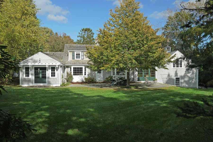 149 East Bay Road Osterville, MA 02655 - Photo 7 of 39 a front view of a house with a garden