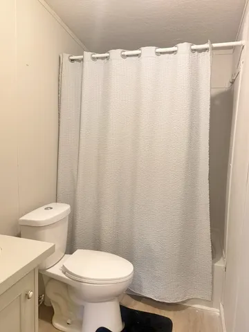 a white toilet sitting next to a white sink