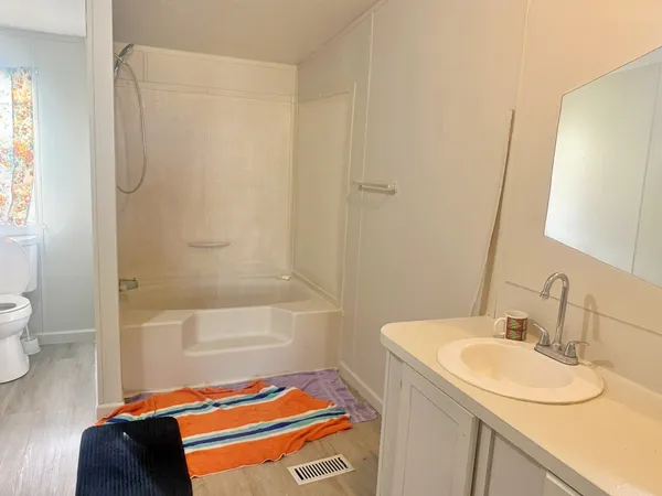a bathroom with a sink a toilet and shower curtain