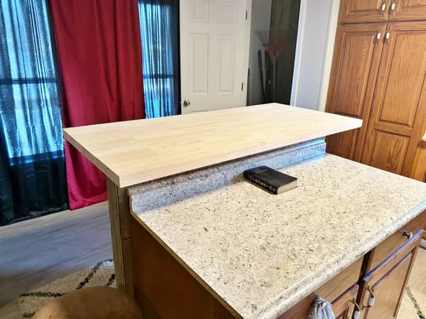a kitchen with a table chairs and a sink