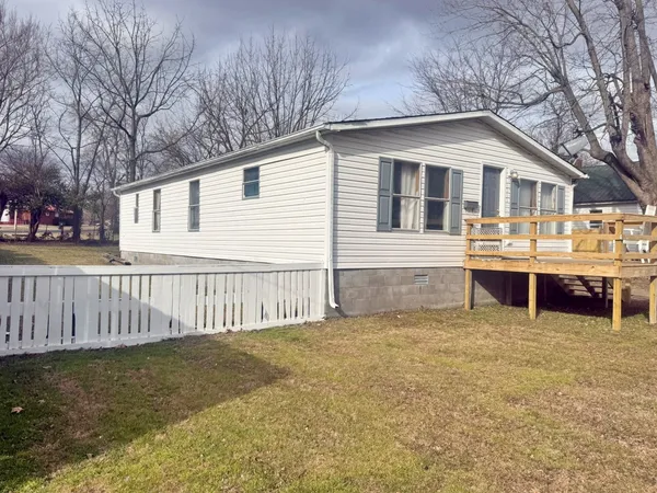 a view of a house with a yard and sitting area
