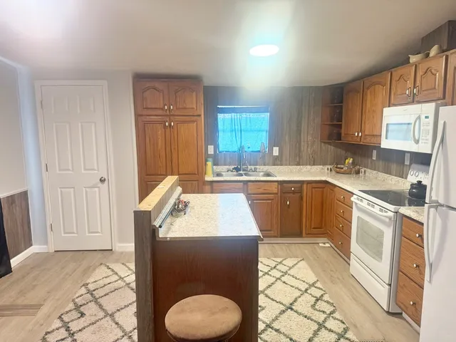 a kitchen with a sink stove and cabinets