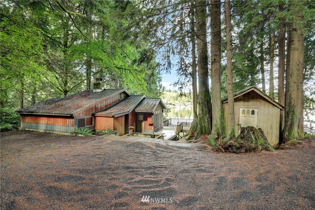 2430 South Lake Roesiger Road Snohomish, WA 98290 - Photo 8 of 12 a house with trees in front of it