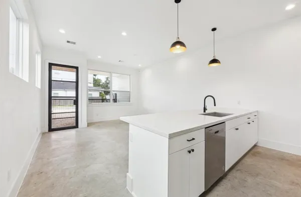 a view of a kitchen with a sink and dishwasher