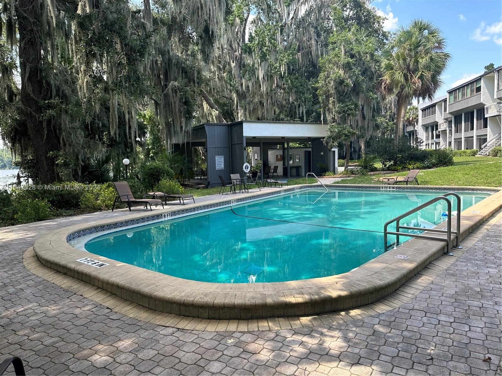 2816 Southwest 14th Drive, Unit 2816 Gainesville, FL 32608 - Photo 14 of 14 a view of a swimming pool with a yard