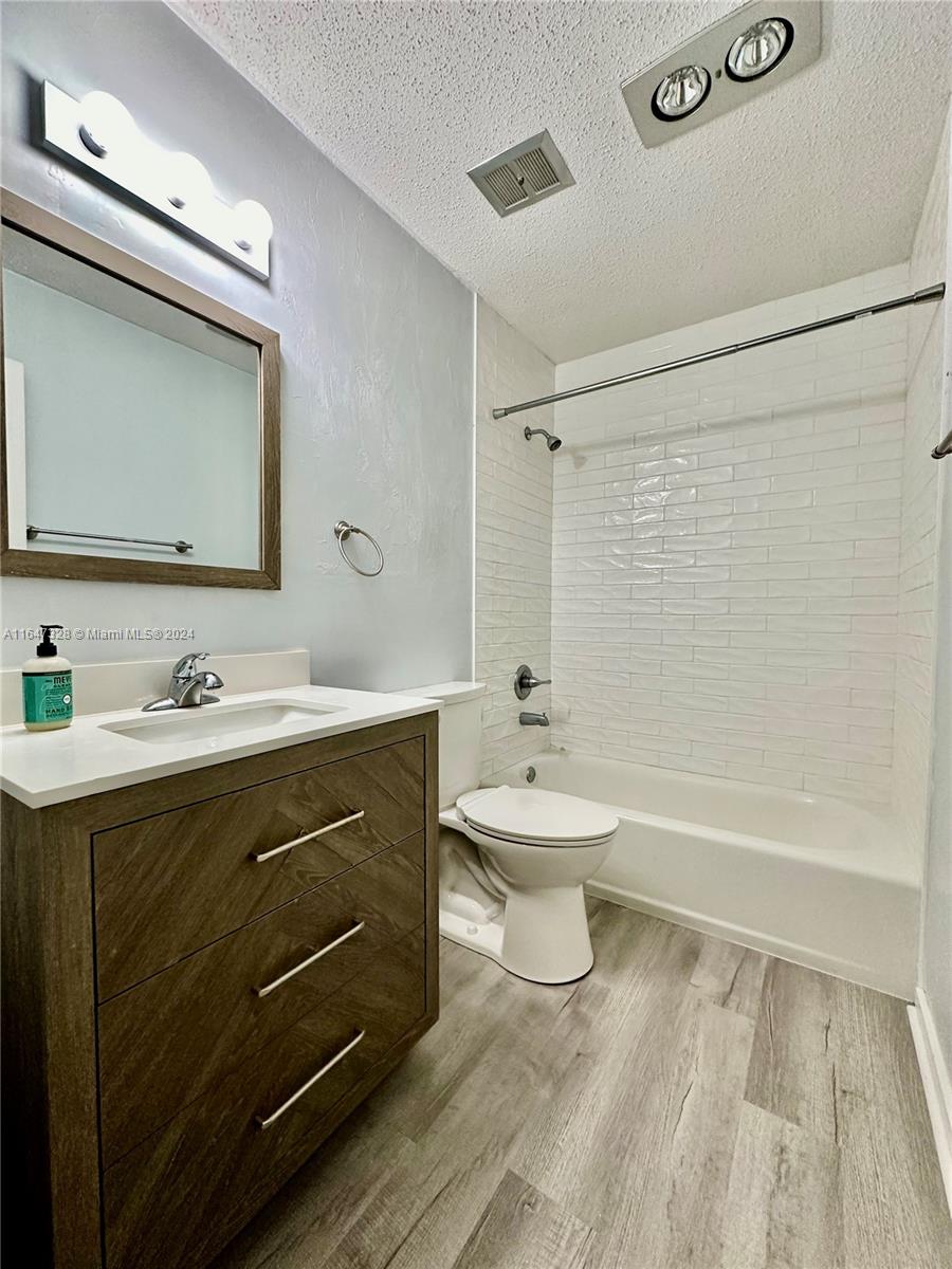 2816 Southwest 14th Drive, Unit 2816 Gainesville, FL 32608 - Photo 8 of 14 a bathroom with a sink a toilet and shower