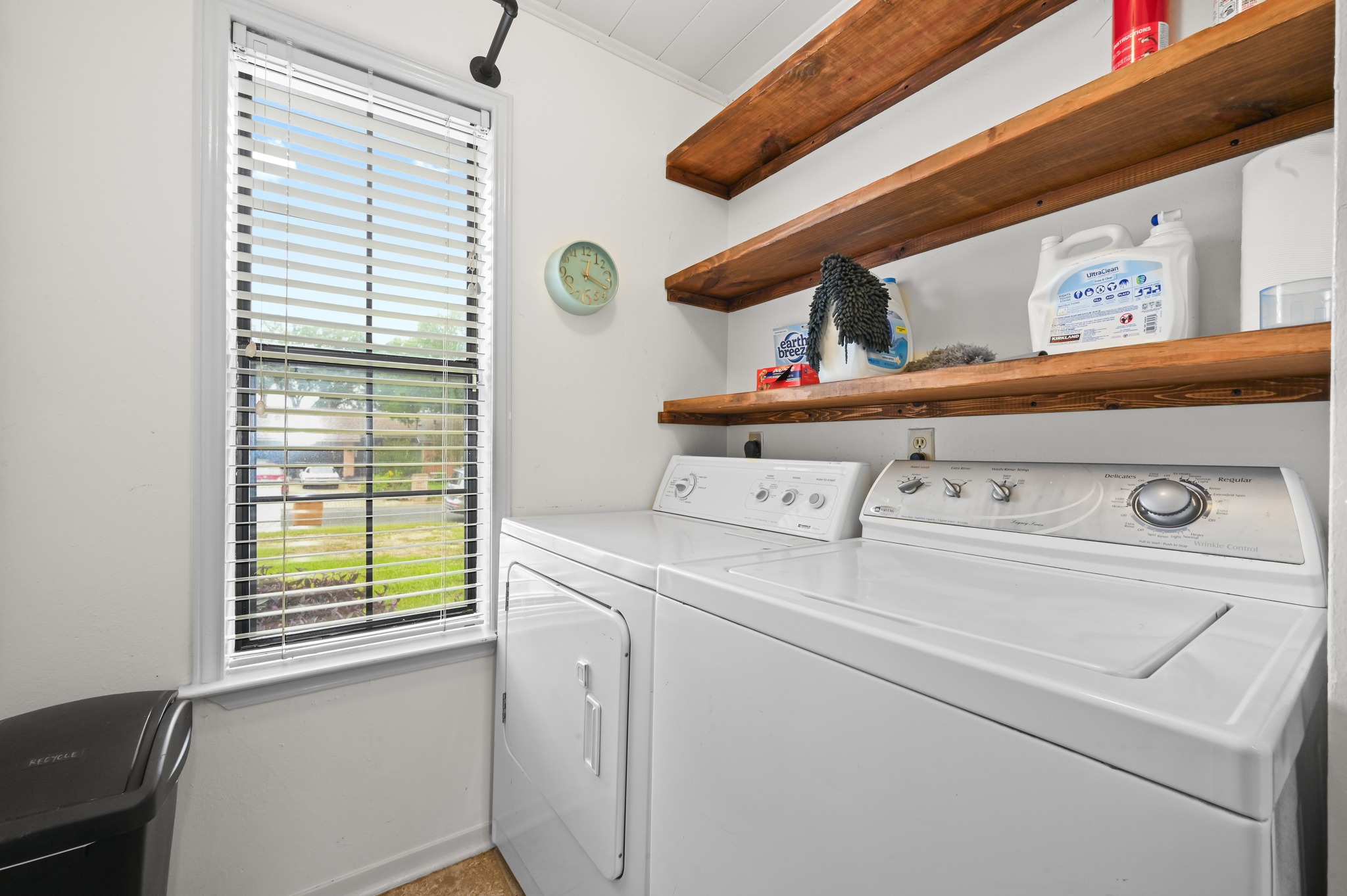 6805 Rearden Road Austin, TX 78745 - Photo 12 of 26 Functional laundry space featuring convenient appliances and ample storage on open shelving.