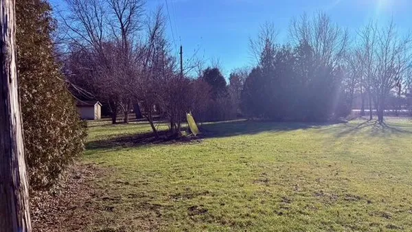 a backyard of a house with lots of green space