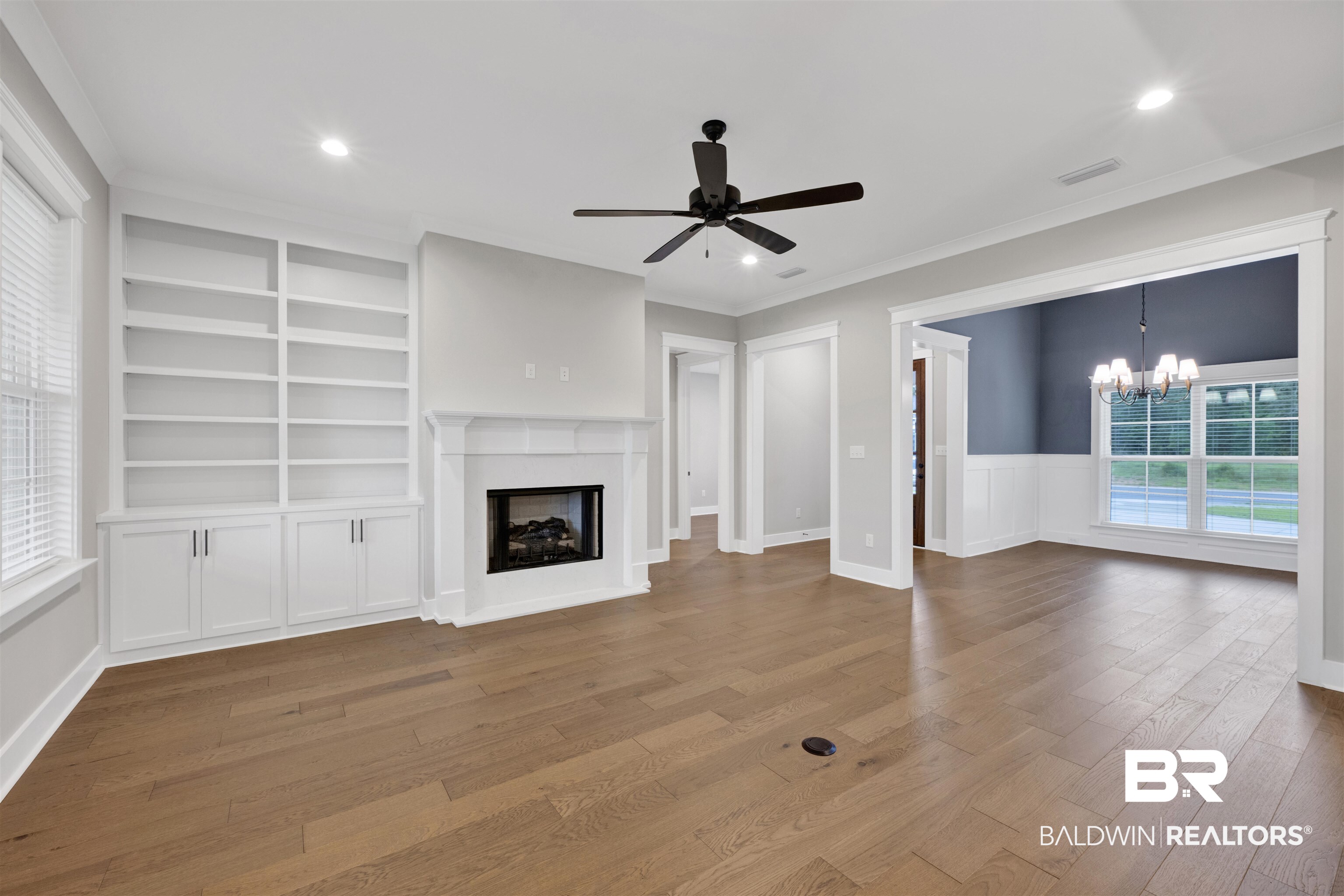 27371 Patch Pl Loop Daphne, AL 36526 - Photo 32 of 63 Living area featuring wood-finish flooring, a fireplace with a white mantel, built-in shelving, a ceiling fan, and recessed lighting