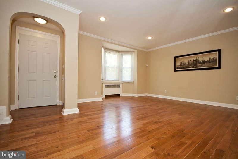 1505 Northgate Road Baltimore, MD 21218 - Photo 1 of 24 a view of an empty room with wooden floor and a window
