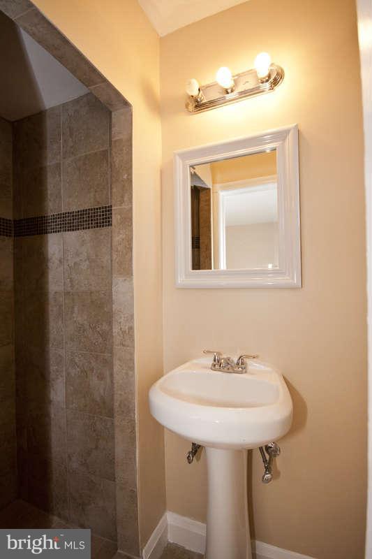1505 Northgate Road Baltimore, MD 21218 - Photo 14 of 24 a bathroom with a sink and mirror