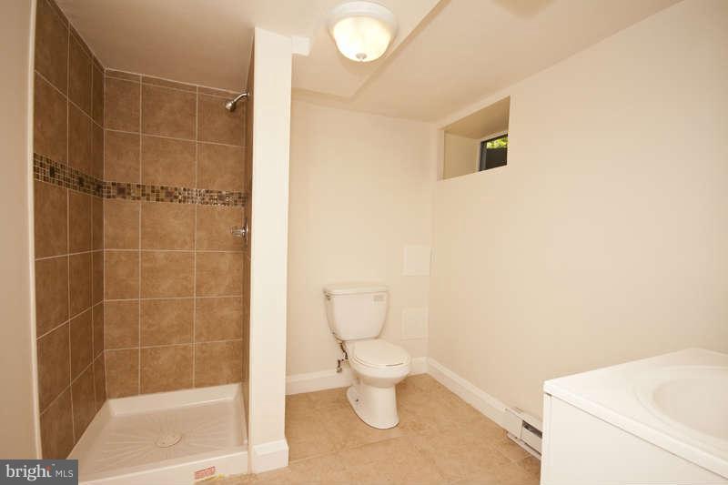 1505 Northgate Road Baltimore, MD 21218 - Photo 18 of 24 a bathroom with a toilet and a shower