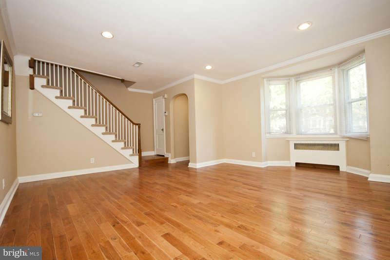 1505 Northgate Road Baltimore, MD 21218 - Photo 3 of 24 a view of an empty room with wooden floor and fan