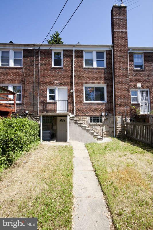 1505 Northgate Road Baltimore, MD 21218 - Photo 22 of 24 a front view of a house with a yard