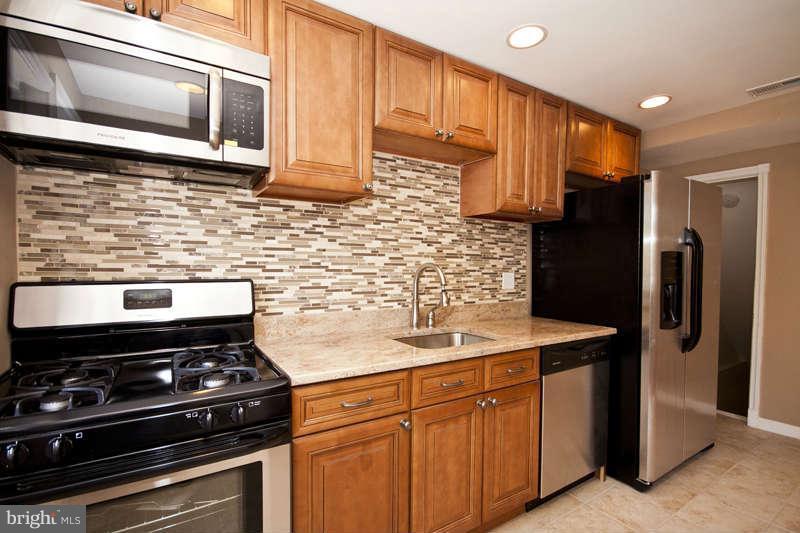 1505 Northgate Road Baltimore, MD 21218 - Photo 5 of 24 a kitchen with stainless steel appliances a stove a refrigerator and a microwave