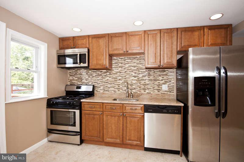 1505 Northgate Road Baltimore, MD 21218 - Photo 6 of 24 a kitchen with stainless steel appliances granite countertop a refrigerator stove top oven a sink and dishwasher