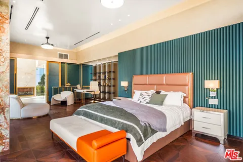 a bedroom with a large bed and a couch