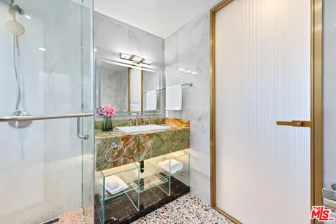 a bathroom with shower and mirror