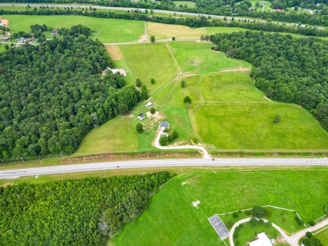 an aerial view of lake residential houses with outdoor space and swimming pool