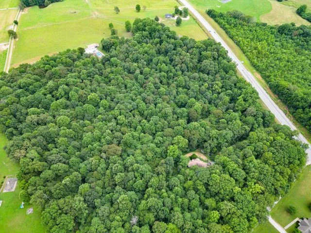 a backyard of a house with a yard and outdoor seating