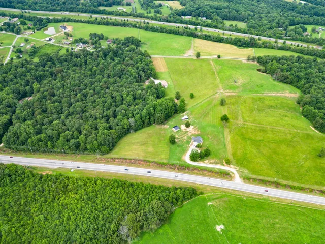 a view of a water pond with green yard