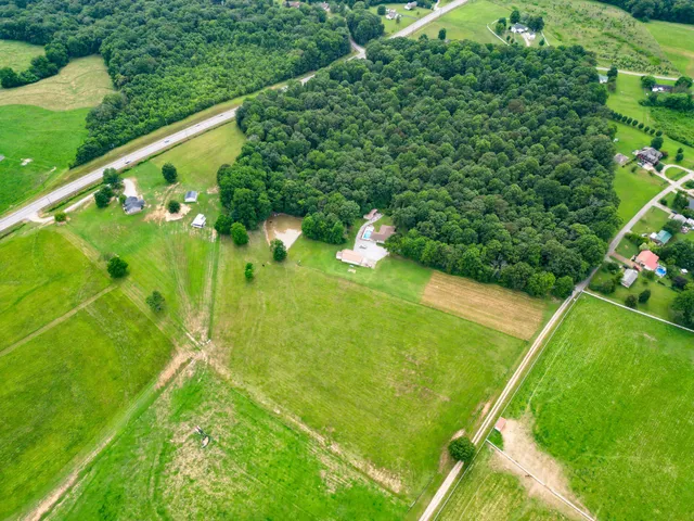 an aerial view of a residential houses with outdoor space and street view
