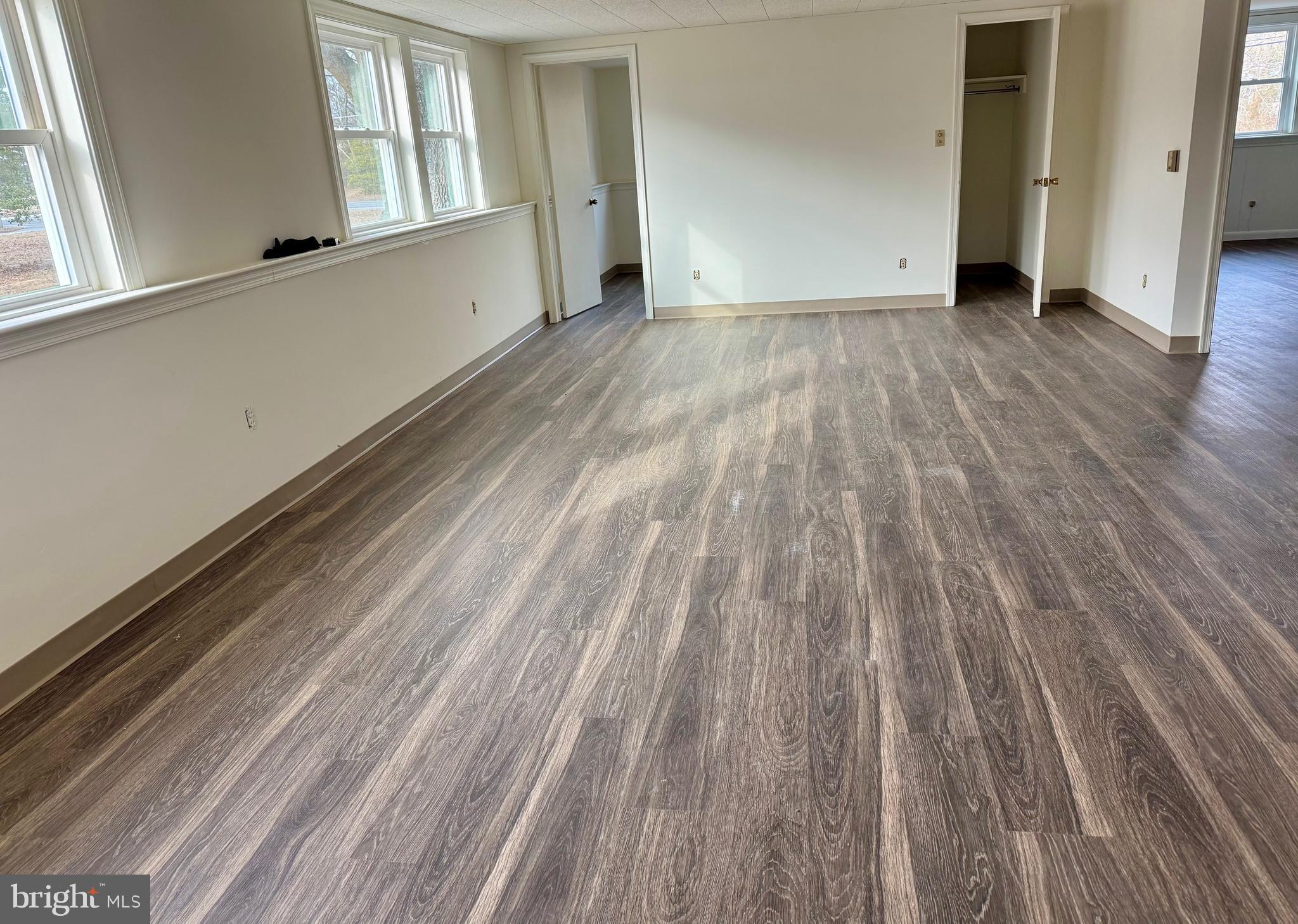 643 Chatsworth Road Tabernacle, NJ 08088 - Photo 5 of 27 a view of an empty room with wooden floor and a window
