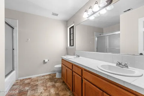 a bathroom with a sink double vanity and a mirror