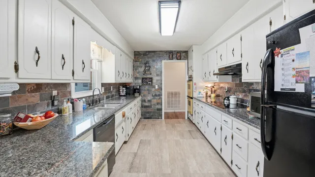 a bedroom that has a bed and a chandelier