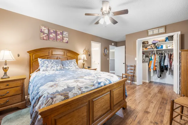 a bedroom with a bed and a chandelier