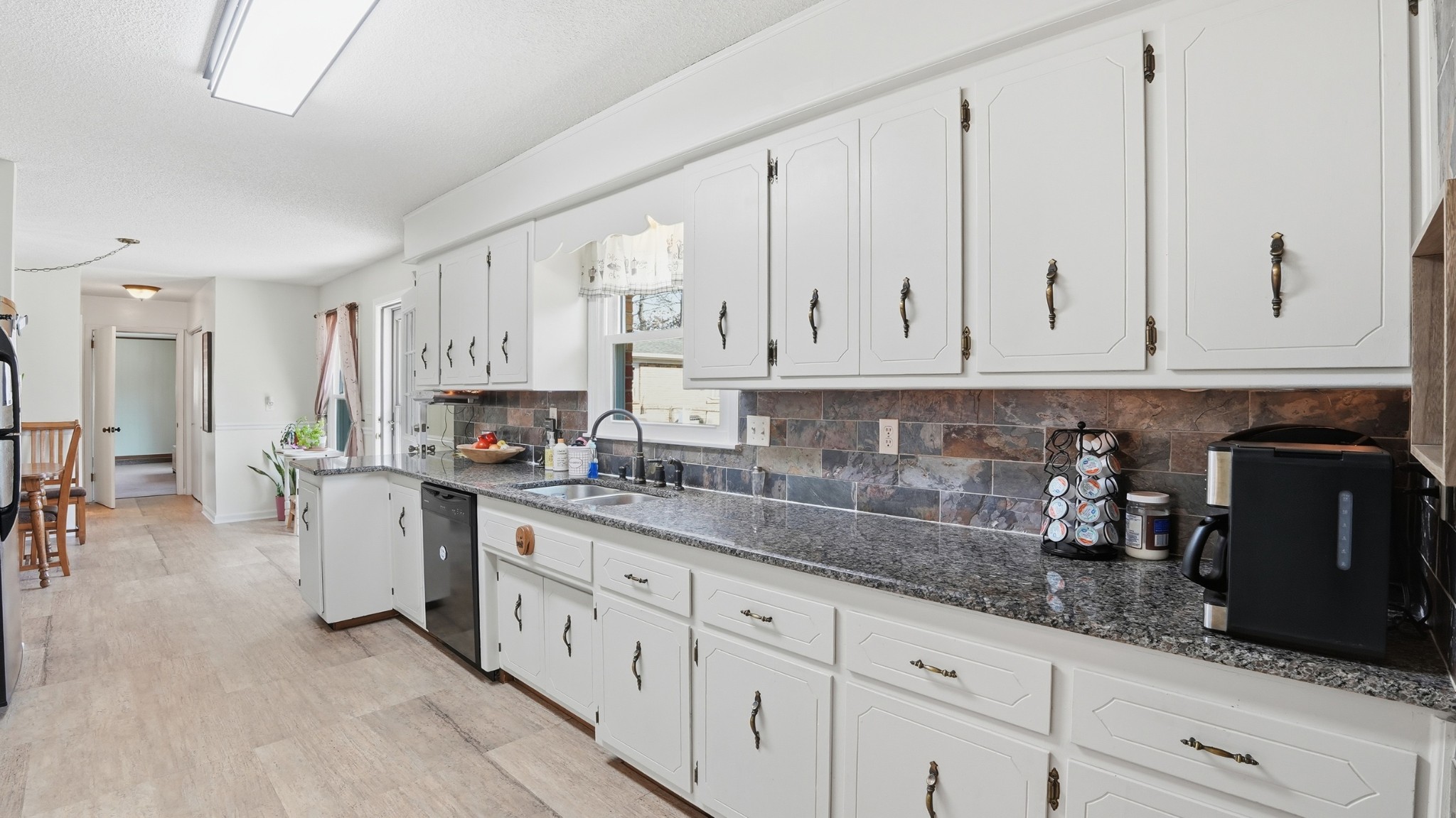 509 12 Oaks Road Tullahoma, TN 37388 - Photo 15 of 60 a kitchen with granite countertop white cabinets and stainless steel appliances