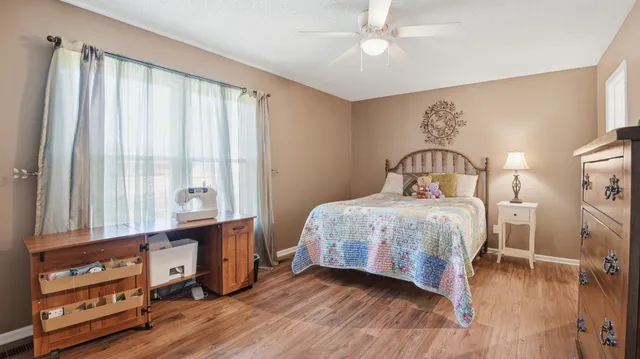 a view of a patio with table and chairs and wooden floor