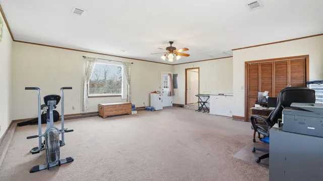 an aerial view of house with yard and mountain view in back