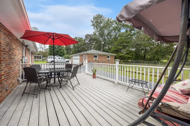 a view of a chair and tables in the balcony