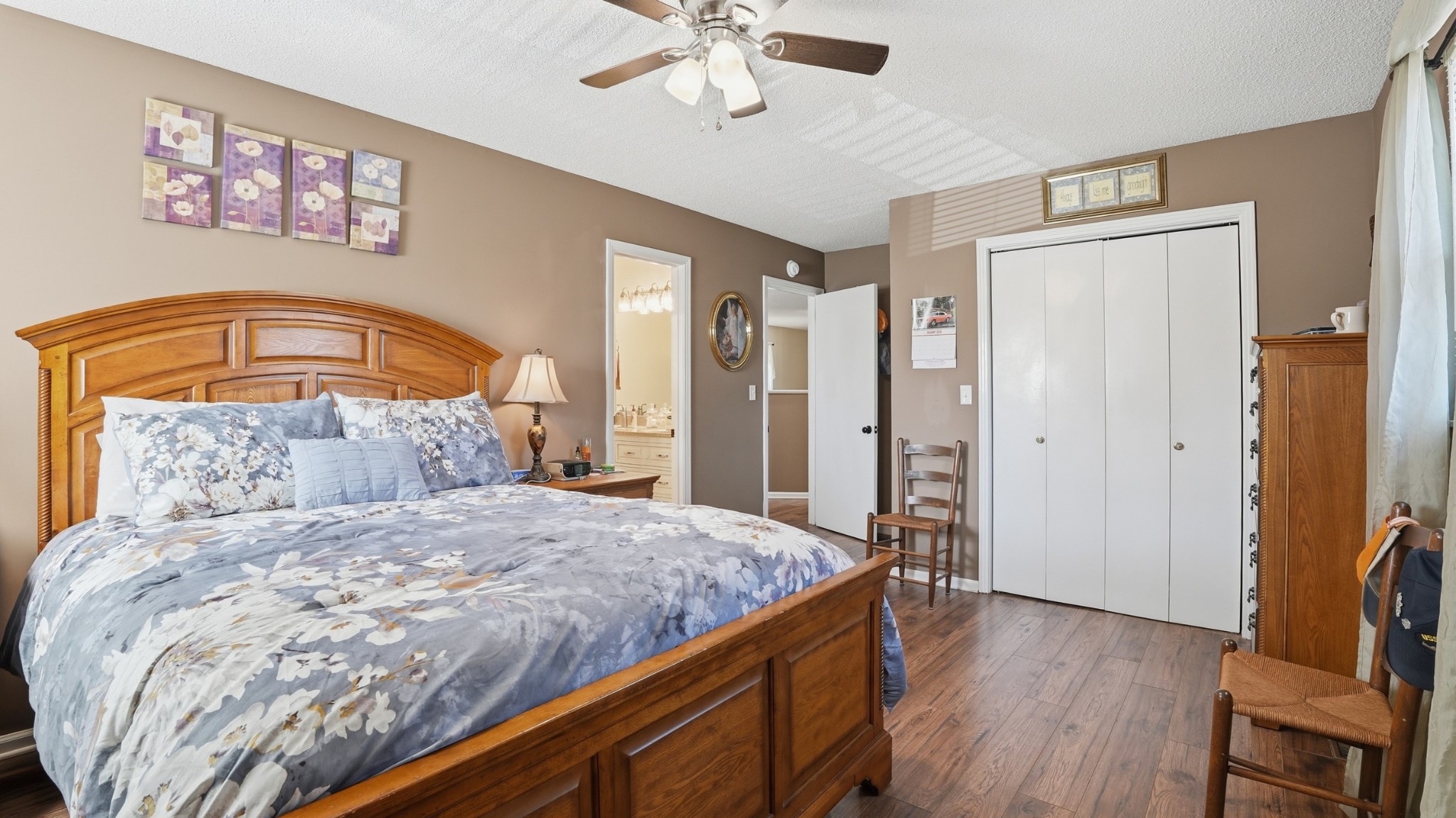 509 12 Oaks Road Tullahoma, TN 37388 - Photo 29 of 60 a bedroom with a large bed and a chandelier